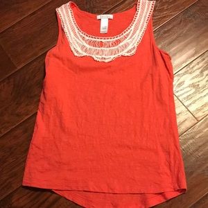Orange tank top with decorative neck.